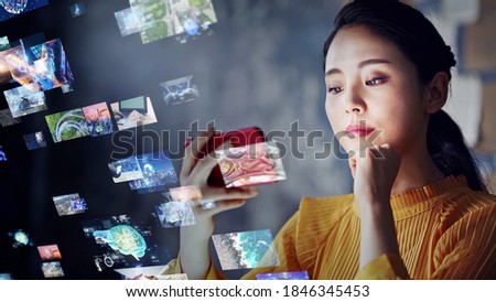 Young asian woman watching a lot of movies. Digital transformation. Royalty-Free Stock Photo #1846345453