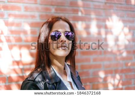 Beautiful woman dressing black jacket, white shirt and dark sunglasses. Lifestyle. street urban style.