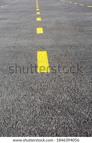 Roads separated by yellow lines, car parks separated by yellow lines