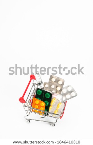 Shopping cart with syringes and pills, medicines