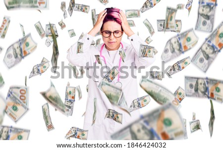 Young beautiful woman with pink hair wearing doctor uniform suffering from headache desperate and stressed because pain and migraine. hands on head.