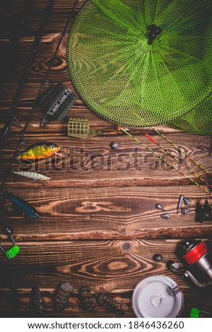 Fishing tackle on a wooden background. Studio photo with vignetting.
