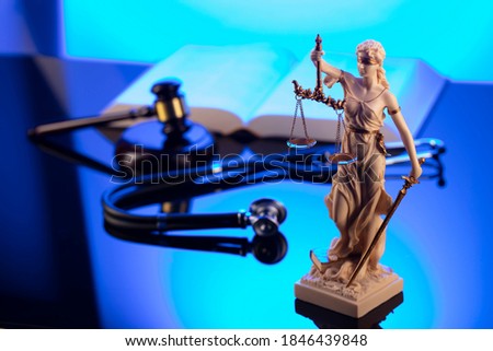 Medical law concept. Judges gavel, stethoscope, blue light. Royalty-Free Stock Photo #1846439848