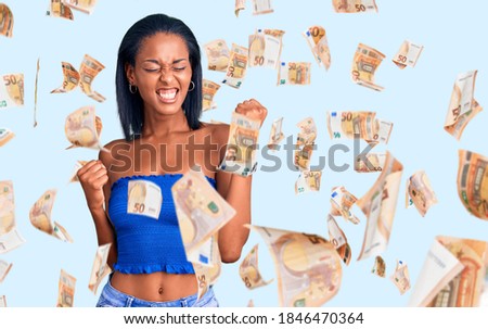 Young african american woman wearing casual summer clothes celebrating surprised and amazed for success with arms raised and eyes closed. winner concept.