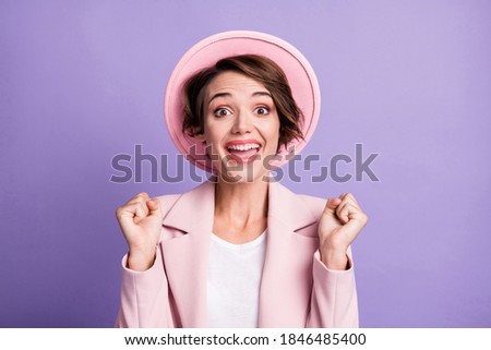 Photo of curly lucky lovely woman wear pink vintage blazer cap arms fists isolated violet color background
