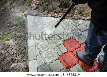 Cleaning paving slab using high pressure power washer