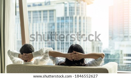 Relaxing couple lifestyle take it easy, lazy resting happily living in luxury city condominium, urban condo apartment, or business hotel tower for life-work balance and life quality concept Royalty-Free Stock Photo #1846552627