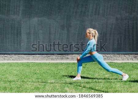 young blonde girl goes in for sports on the street