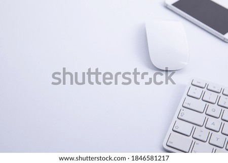 new modern keyboard with computer mouse and smartphone isolated on white background, close view . High quality photo