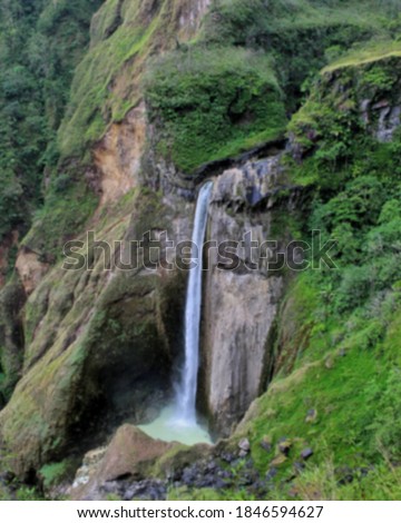 beautiful waterfalls landscape with trees and rocks blurred.  blurry background 
