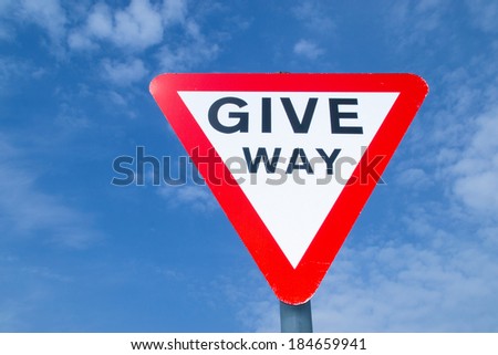 The "Give Way" sign with brilliant blue skies in background.