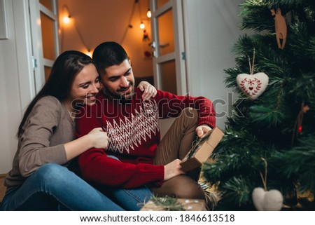 loving couple sharing love and gifts for new years eve