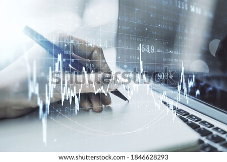 Multi exposure of abstract creative financial graph with hand writing in notepad on background, forex and investment concept