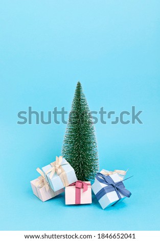Christmas tree with ornaments over blue pastel background. Minimal picture for winter holidays, xmas and new year celebration greeting card
