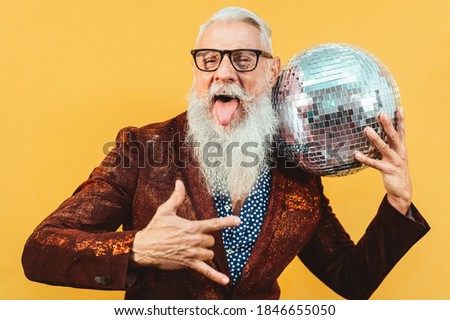 Senior party man celebrating new year's eve in disco club 