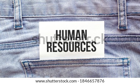 HUMAN RESOURCES words on a white paper stuck out from jeans pocket. Business concept