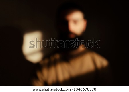 Blurred Man Highlighted By Light Rays