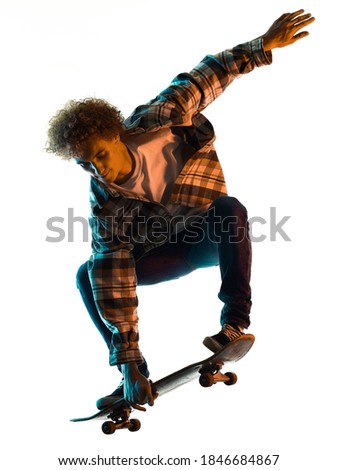 one caucasian young man skateboarder Skateboarding in studio silhouette shadow isolated on white background