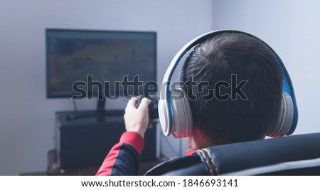 Man playing video game in home.