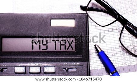 A calculator with text My Tax on the display