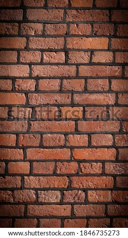 Full frame image of the old red brick wall. High resolution texture (vertical 16:9 format) with dark vignetted corners for wallpaper, background, poster or collage, copy space