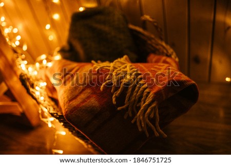 New Year 2021 interior with candles, bulbs and bokeh. Room decorated to christmas celebration. Christmas tree with presents