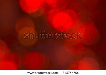 Abstract red backlight reflector and glitter bokeh lights background. Image is blurred 