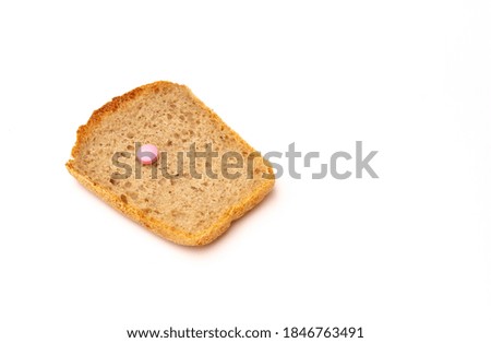 Pink pill and toast bread on a white background