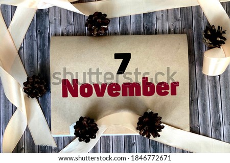 November 7 on craft paper on a wooden background.Autumn .Calendar for November.