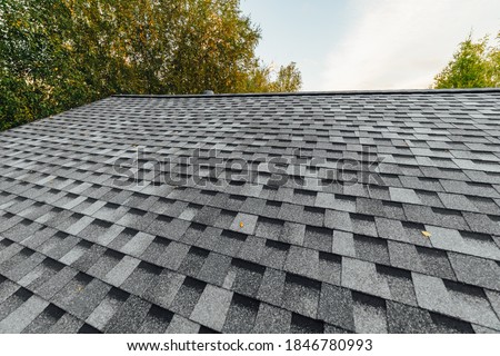new renovated roof covered with shingles flat polymeric roof-tiles Royalty-Free Stock Photo #1846780993