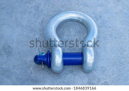 Closeup anchor shackles on cement background Royalty-Free Stock Photo #1846839166