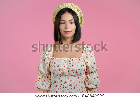 Young smiling woman looking to camera. Portrait of cute beautiful girl on pink studio wall background. Royalty-Free Stock Photo #1846842595