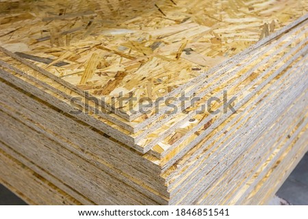 OSB - Oriented strand board. Stacked OSB sheets. Sheet material for the construction of frame houses Royalty-Free Stock Photo #1846851541