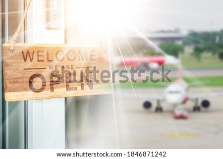 open signboard hanging at the door on airport background