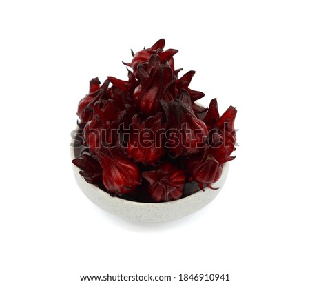 red hibiscus flowers in bowl isolated on white background