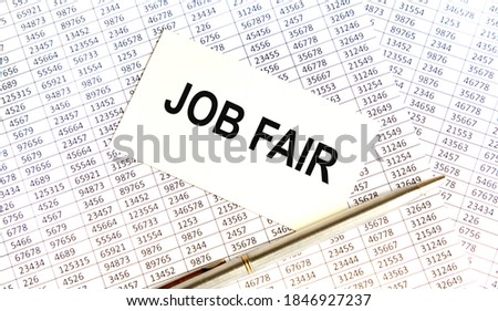 On the business card the text job FAIR, next to the pen, everything lies on the background of reports.