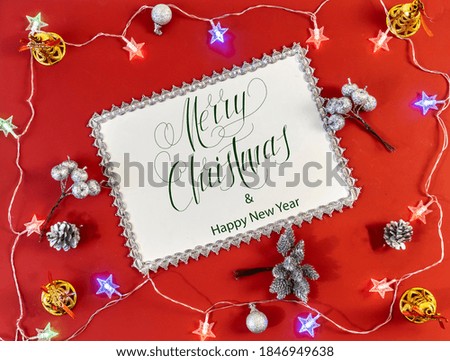 Happy New Year and Merry Christmas!  flat lay, with text - Merry Christmas, on a red background