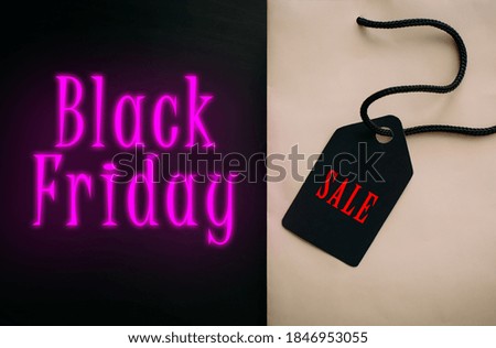 Shopping, sales, black Friday, discounts. Concept image of a paper bag with black handles and stylish lettering.