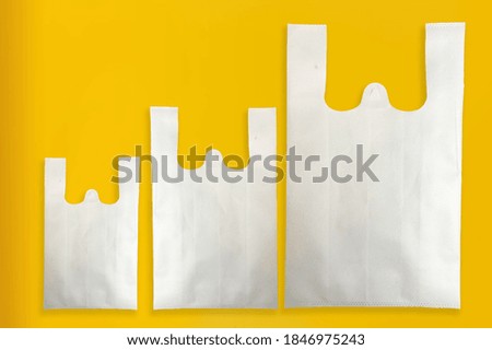 Beautiful W-Cut Non Woven grocery shopping bag with yellow background Royalty-Free Stock Photo #1846975243