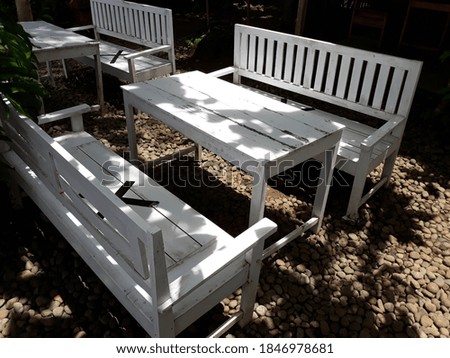 The white wooden chairs in the park look attractive
