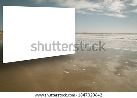 Blank 3D mockup screen on a beach with clouds reflected in wet sand. Outdoor advertisement concept.  Royalty-Free Stock Photo #1847020642