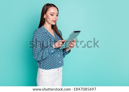 Photo of concentrated agent girl chatting with partners on tablet isolated over teal pastel color background