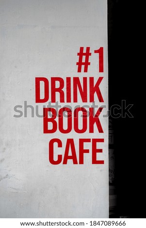 "drink, book, cafe" text on the cafe wall.