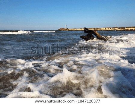 Rocky beach in black sea with waves