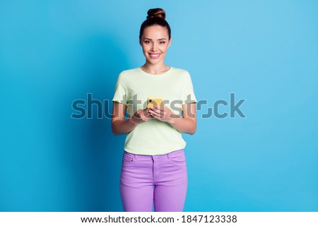 Portrait of her she nice-looking attractive lovely gorgeous cheerful cheery brown-haired girl using device browsing web wi-fi isolated over bright vivid shine vibrant blue color background