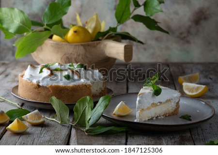 Homemade lemon cheesecake with lemon basil curd and Italian meringue. Cook book or recipe cover. Scandinavian design. Horizontal