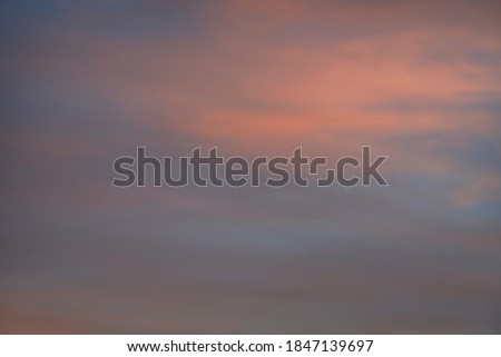 Cloud in the sky at sunset texture background. Red, orange and blue abstract shades. True high resolution photography