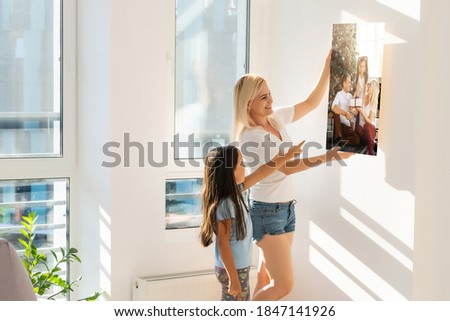 family holds holds photo canvas at home