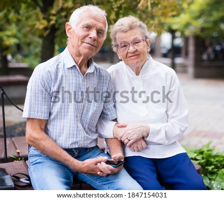 mature couple of man with woman sitting on bench in spring Royalty-Free Stock Photo #1847154031