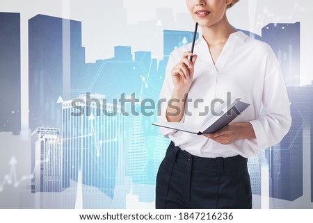 Unrecognizable thoughtful businesswoman standing with planner in blurry city with double exposure of financial graph. Toned image